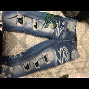 Blue Amiri jeans with snake emblem and snakeskin